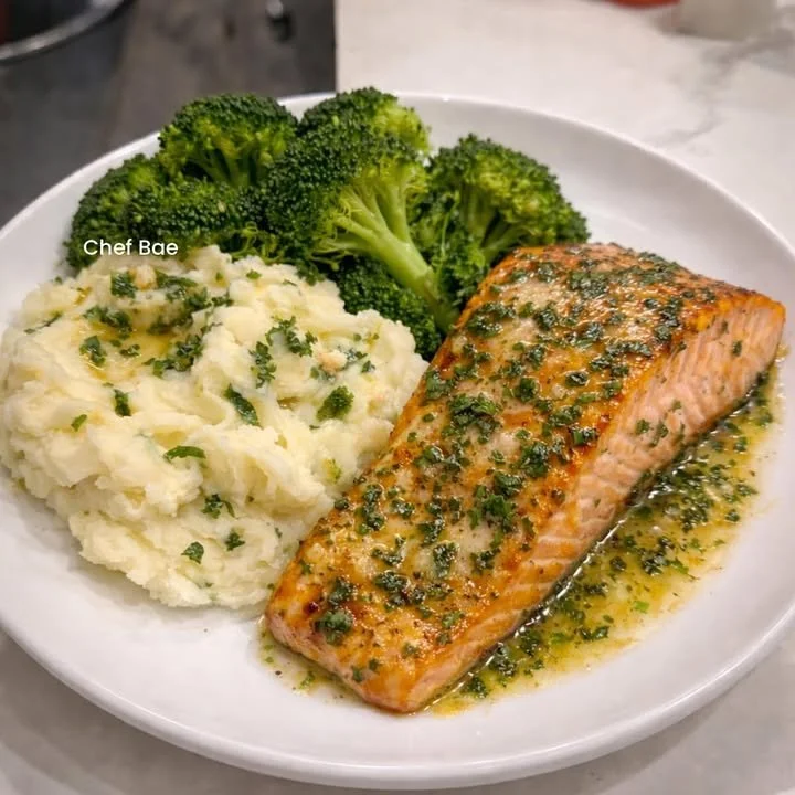 Delicious Garlic Butter Salmon Plate with herbs and lemon