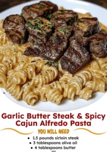 A plate of garlic butter steak served with pasta, garnished with herbs