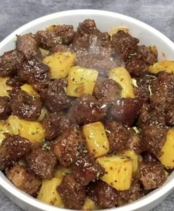 Garlic butter steak and potatoes skillet garnished with herbs