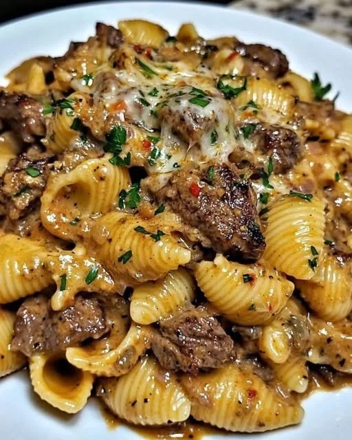Delicious Garlic Butter Steak Bites with creamy Parmesan shells on a plate.