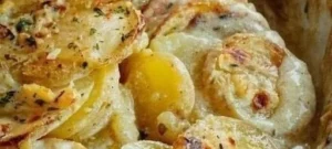 Garlic lemon butter seared scallops plated with herbs and lemon slices.