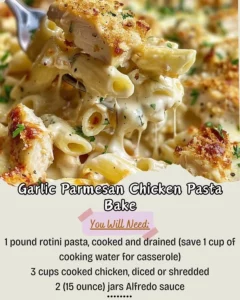 Garlic Parmesan Chicken Pasta Bake with melted cheese and herbs in a baking dish