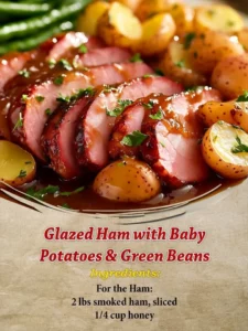 Glazed ham served with baby potatoes and green beans on a festive table.