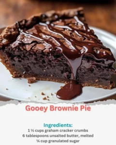 Delicious gooey brownie pie topped with chocolate drizzle and walnuts