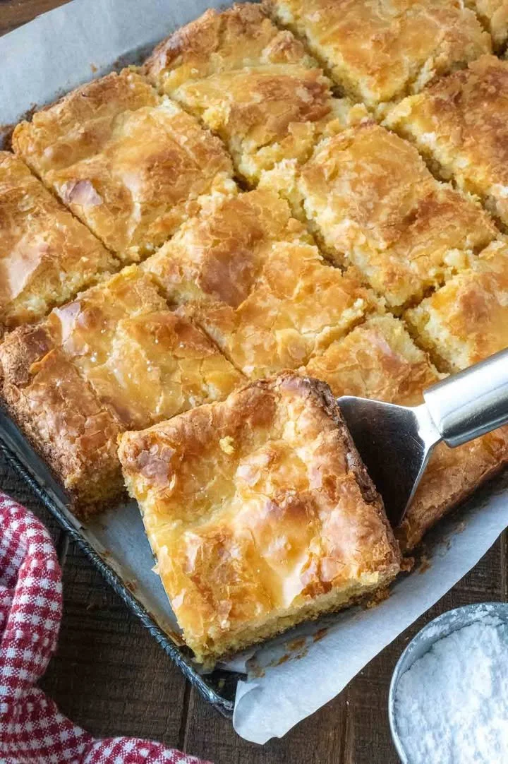 Delicious Gooey Butter Cake Bars topped with powdered sugar