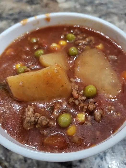 Bowl of homemade Grandma's Hamburger Soup, filled with vegetables and ground beef.