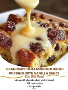 Bowl of Grandma's old-fashioned bread pudding with creamy vanilla sauce on top.