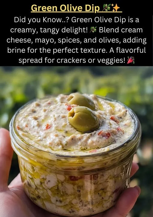 A bowl of homemade Green Olive Dip with fresh herbs and pita bread on the side.