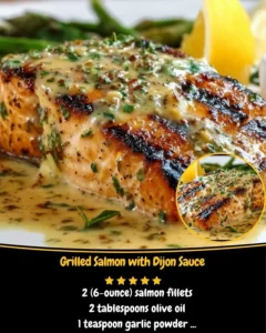 Grilled salmon fillet topped with Dijon sauce served on a plate.