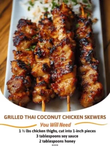 Grilled Thai coconut chicken skewers served on a platter with dipping sauce