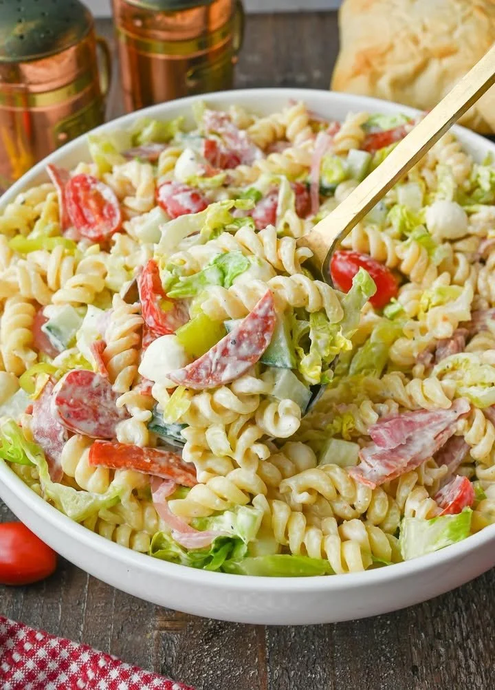Colorful Grinder Pasta Salad with fresh vegetables and dressing