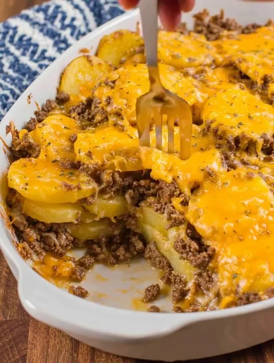 Delicious ground beef potato casserole topped with cheese and herbs