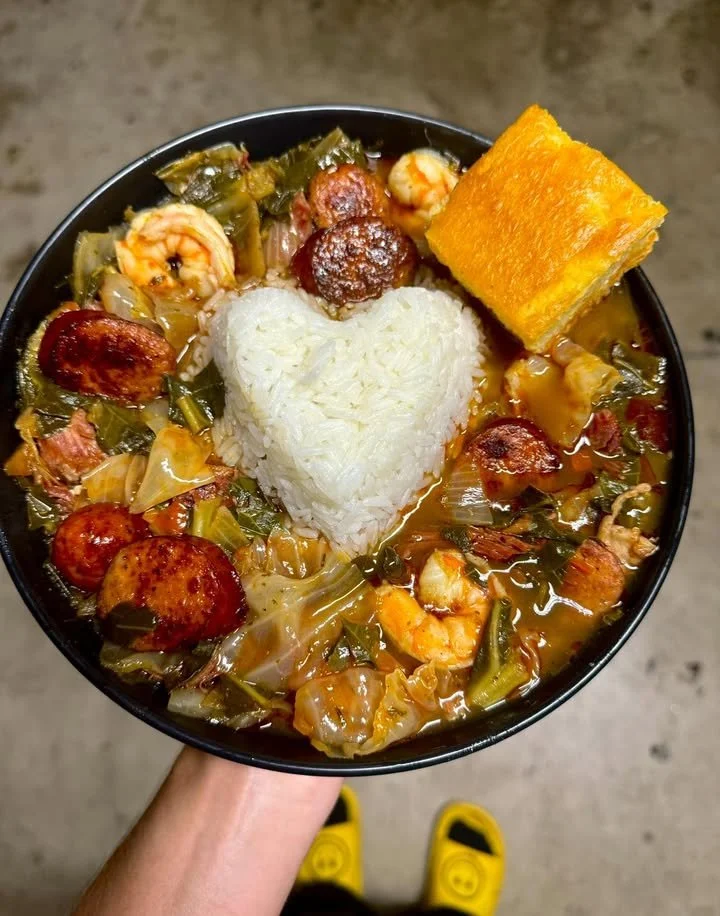 Bowl of Gumbo Greens with Cabbage, Rice, and Cornbread served on a table
