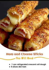 Ham and cheese sticks served on a platter with dipping sauce.