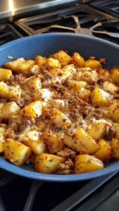 Delicious hamburger hash with ground beef, potatoes, and vegetables in a skillet.