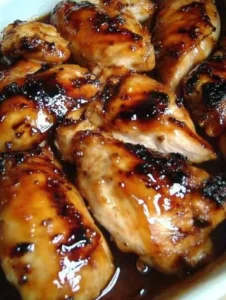 Crispy Hawaiian Grilled Teriyaki Chicken garnished with fresh herbs.