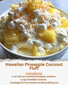 Hawaiian Pineapple Coconut Fluff dessert in a bowl with fresh pineapple and coconut.