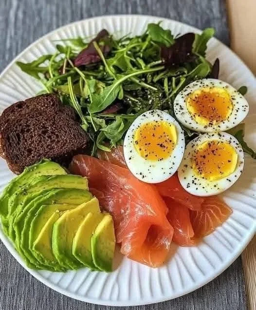 Healthy Mediterranean smoked salmon avocado toast with fresh toppings.