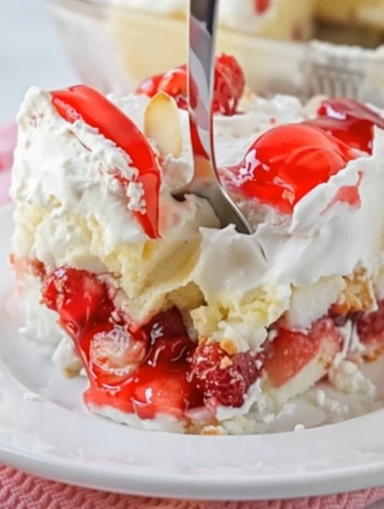 Heaven On Earth Cake topped with whipped cream and fruit