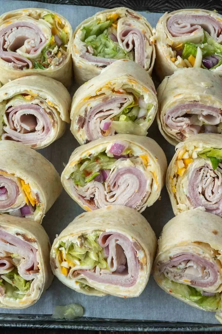 High Roller Pinwheel Sandwiches with colorful fillings rolled and sliced.