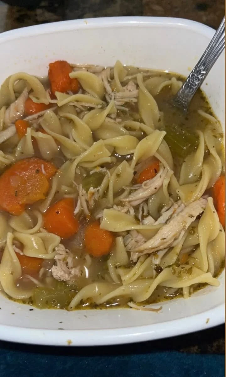 Bowl of homemade chicken noodle soup with fresh ingredients