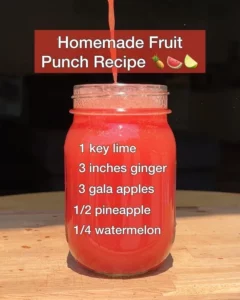 A refreshing bowl of homemade fruit punch with colorful mixed fruits.