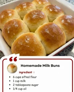 Freshly baked homemade milk buns on a rustic wooden table