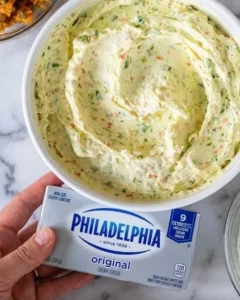 A variety of colorful homemade spreads displayed on a wooden table.