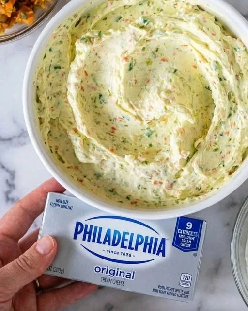 A variety of colorful homemade spreads displayed on a wooden table.