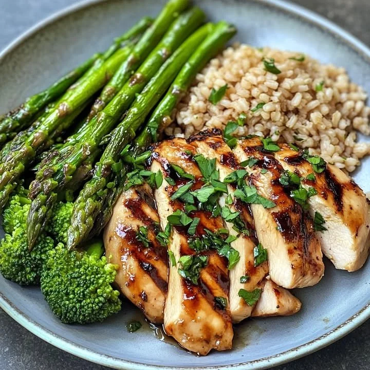 Honey Garlic Chicken served with farro and roasted broccolini on a plate