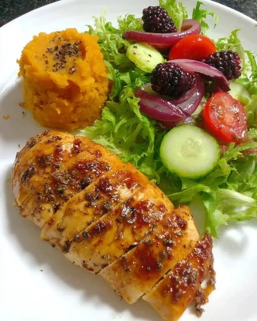Honey Garlic Chicken with Sweet Potato Mash and Berry Salad on a plate