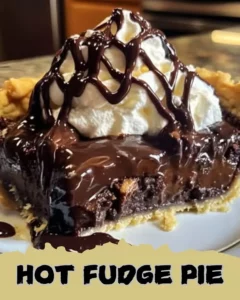 Deliciously rich Hot Fudge Pie served with a scoop of vanilla ice cream.