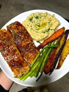 Delicious hot honey salmon served with roasted rainbow carrots and garlic mashed potatoes