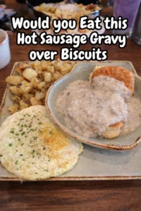 Hot sausage gravy served over flaky biscuits, a comforting breakfast dish.