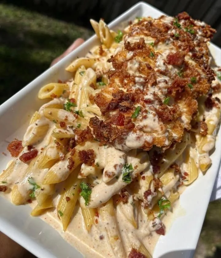 Delicious plate of pasta garnished with fresh herbs and cheese