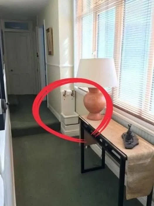 Small sink installed in a hallway, raising questions about its historical use