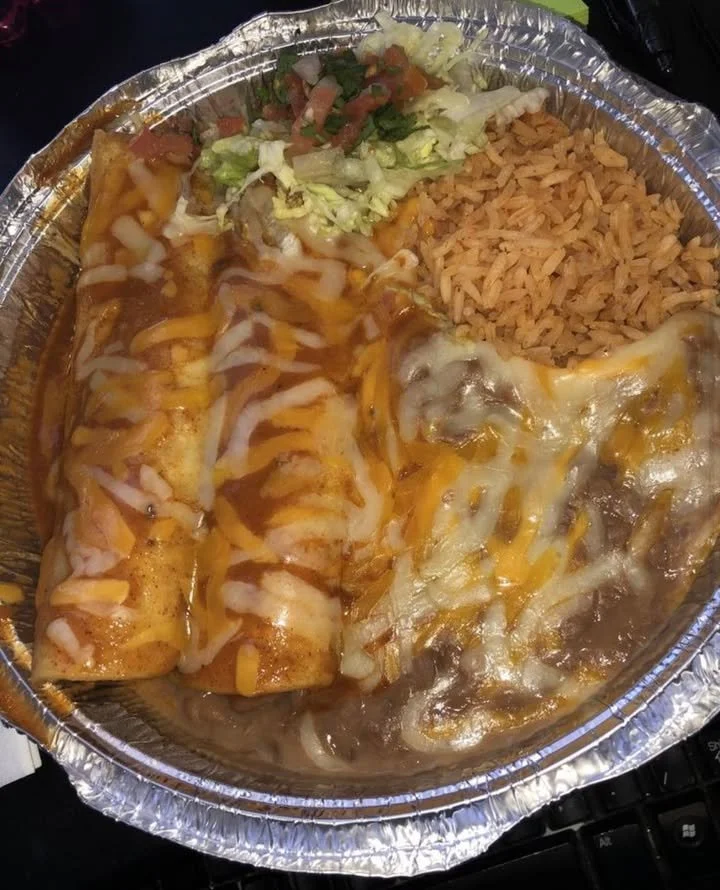 Delicious plate of enchiladas topped with cheese and fresh ingredients