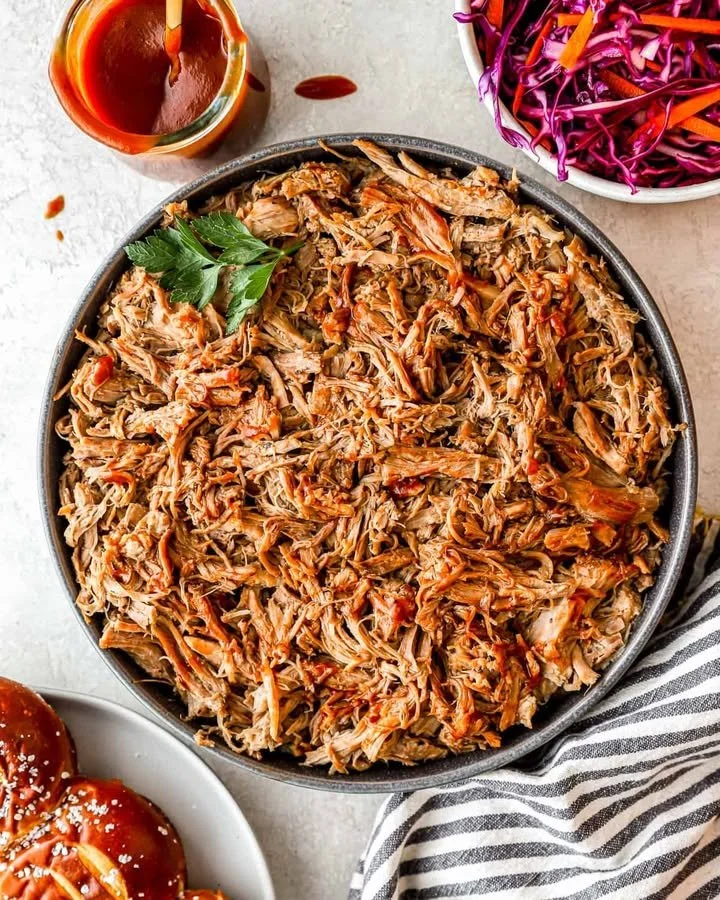 Delicious Instant Pot pulled pork served in a sandwich with coleslaw