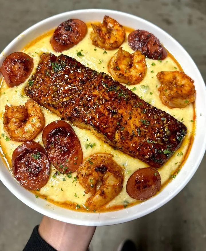 Jalapeno cheddar grits topped with sautéed shrimp, sausage, and salmon