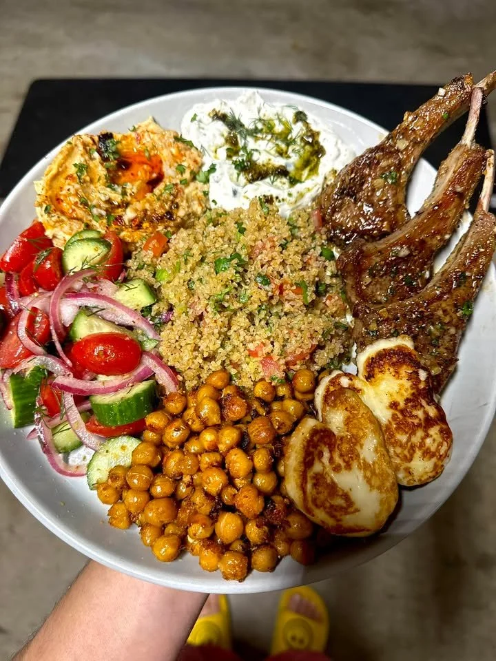 Delicious lamb chops served with tabbouleh, halloumi, and vibrant salads.