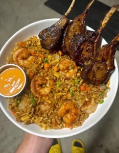 Lamb chops paired with shrimp fried rice, an enticing meal combination