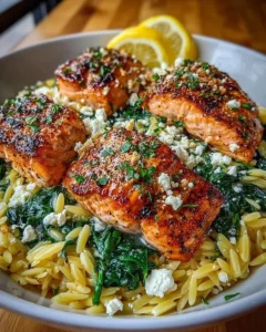Lemon Butter Salmon served with orzo, spinach, and feta cheese in a bowl.