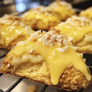 Lemon Coconut Cheesecake Cookies on a plate garnished with lemon zest and coconut flakes