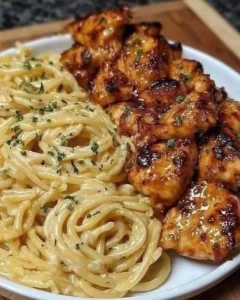 Lemon Garlic Butter Chicken with creamy parmesan pasta on a plate