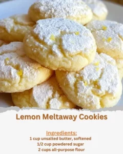 Freshly baked Lemon Meltaway Cookies on a white plate with lemon slices.