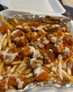 Delicious loaded fries topped with cheese, bacon, and toppings