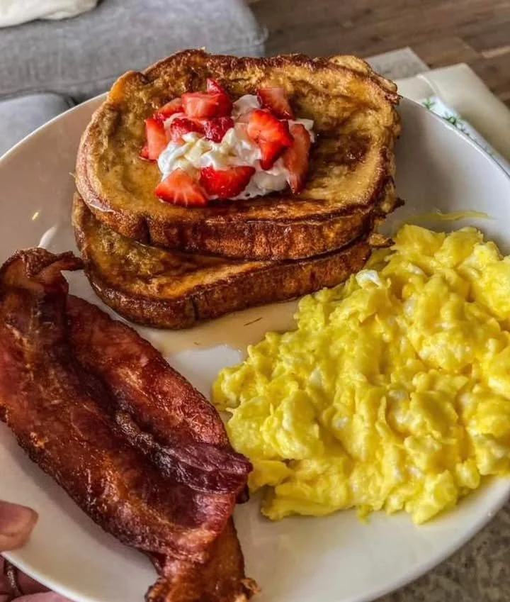 Delicious French toast served with syrup and fresh berries