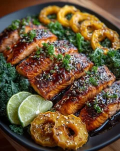 Maple-Miso Glazed Salmon with roasted delicata squash and crispy kale on a plate.