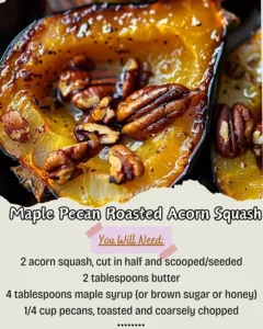 Delicious Maple Pecan Roasted Acorn Squash garnished with maple syrup and pecans.