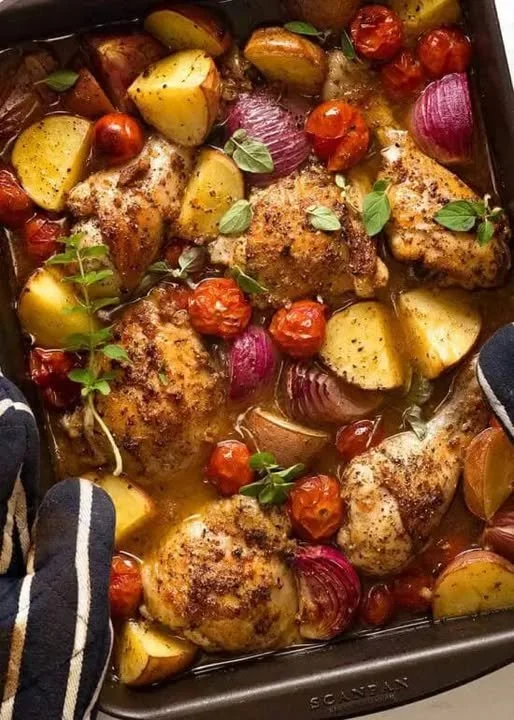 Mediterranean baked chicken dinner with herbs and vegetables